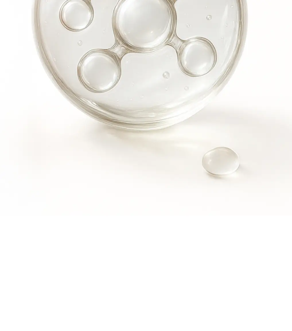 Clear liquid droplets on a white surface.