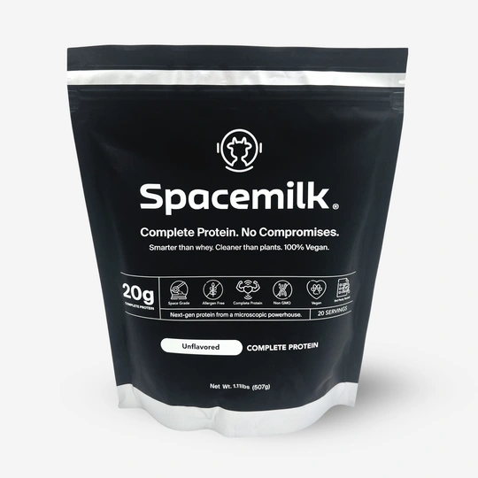 Black package labeled 'Spacemilk' complete protein, 100% vegan, with 20g protein per serving.