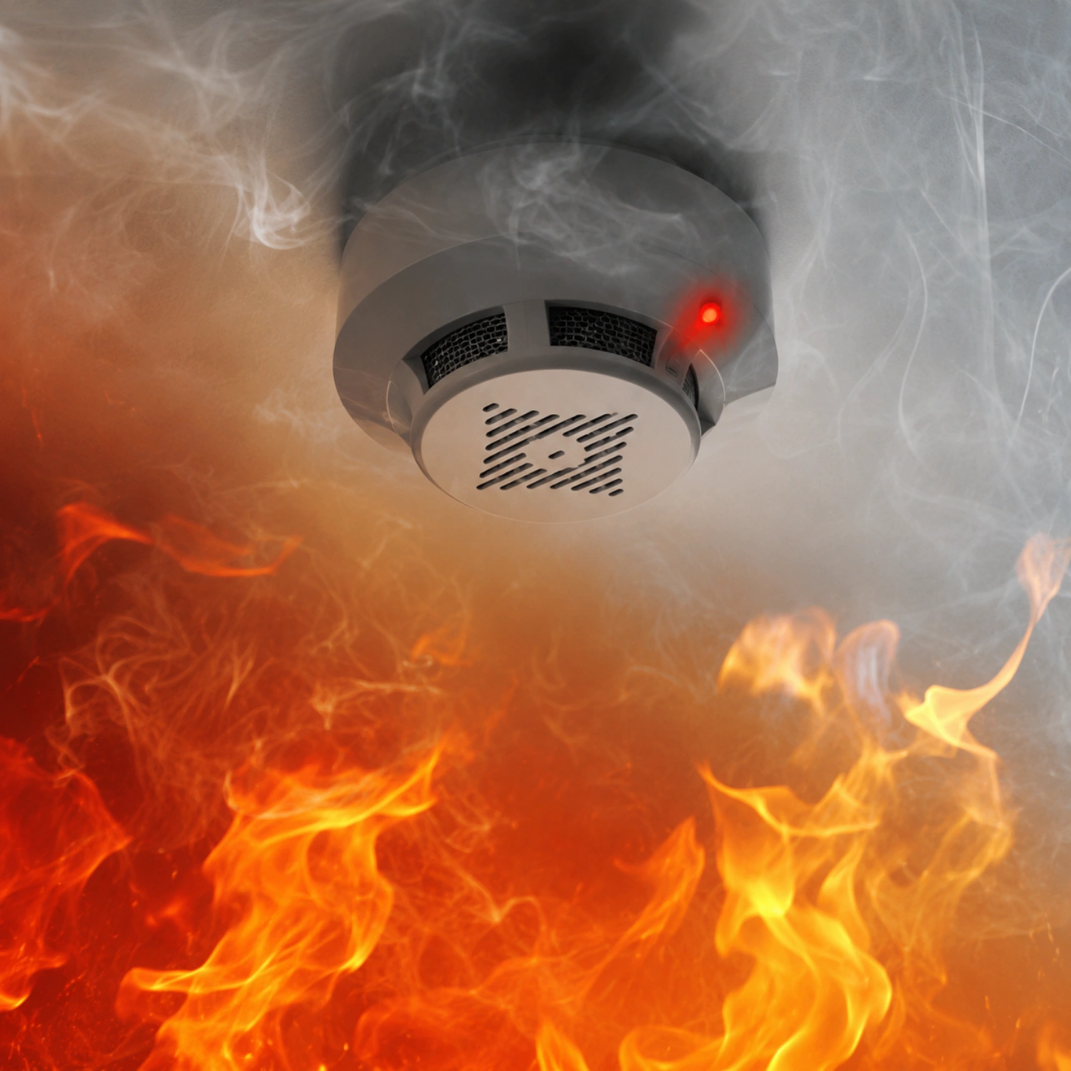 A smoke detector with a red light on the ceiling detects smoke rising from a fire below.
