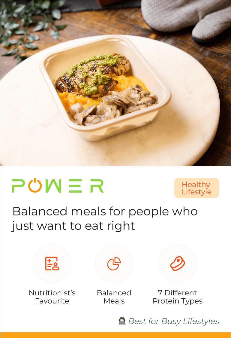 Meal in a container with chicken, mushrooms, and sauce on a table.
