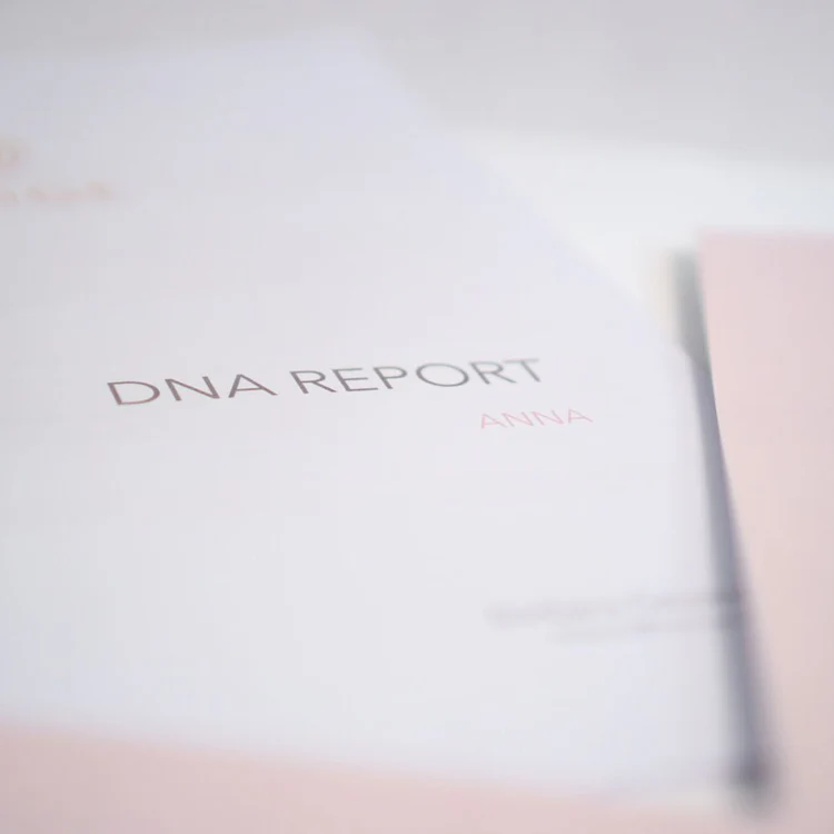 Close-up of a document titled 'DNA Report' with the name 'Anna'.
