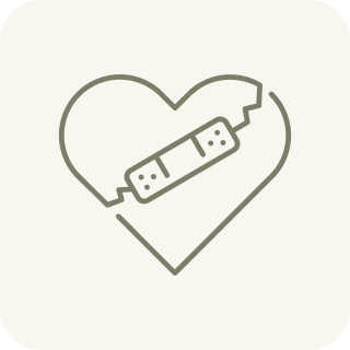 An icon of a cracked heart with a bandage holding it together.