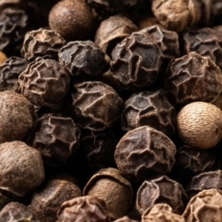 Close-up of black peppercorns clustered together.