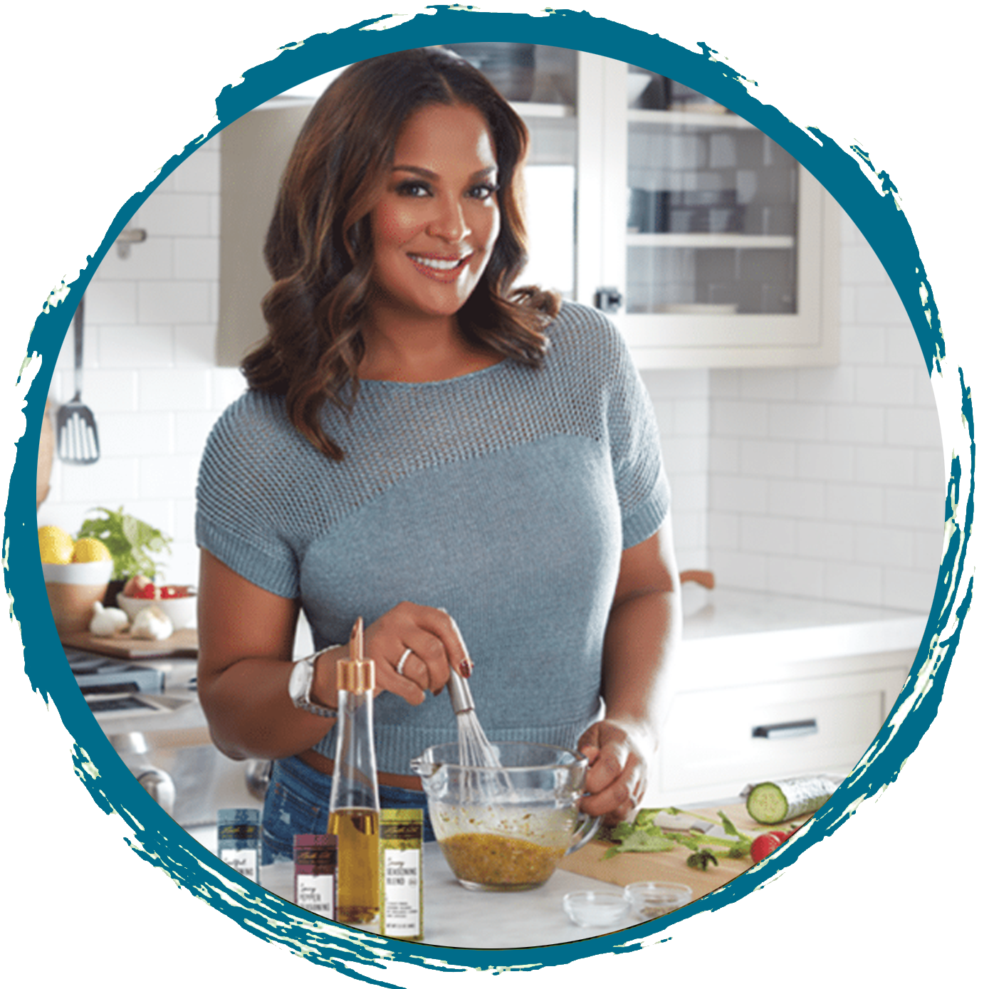 Woman in kitchen whisking ingredients in a bowl, surrounded by vegetables and bottles.