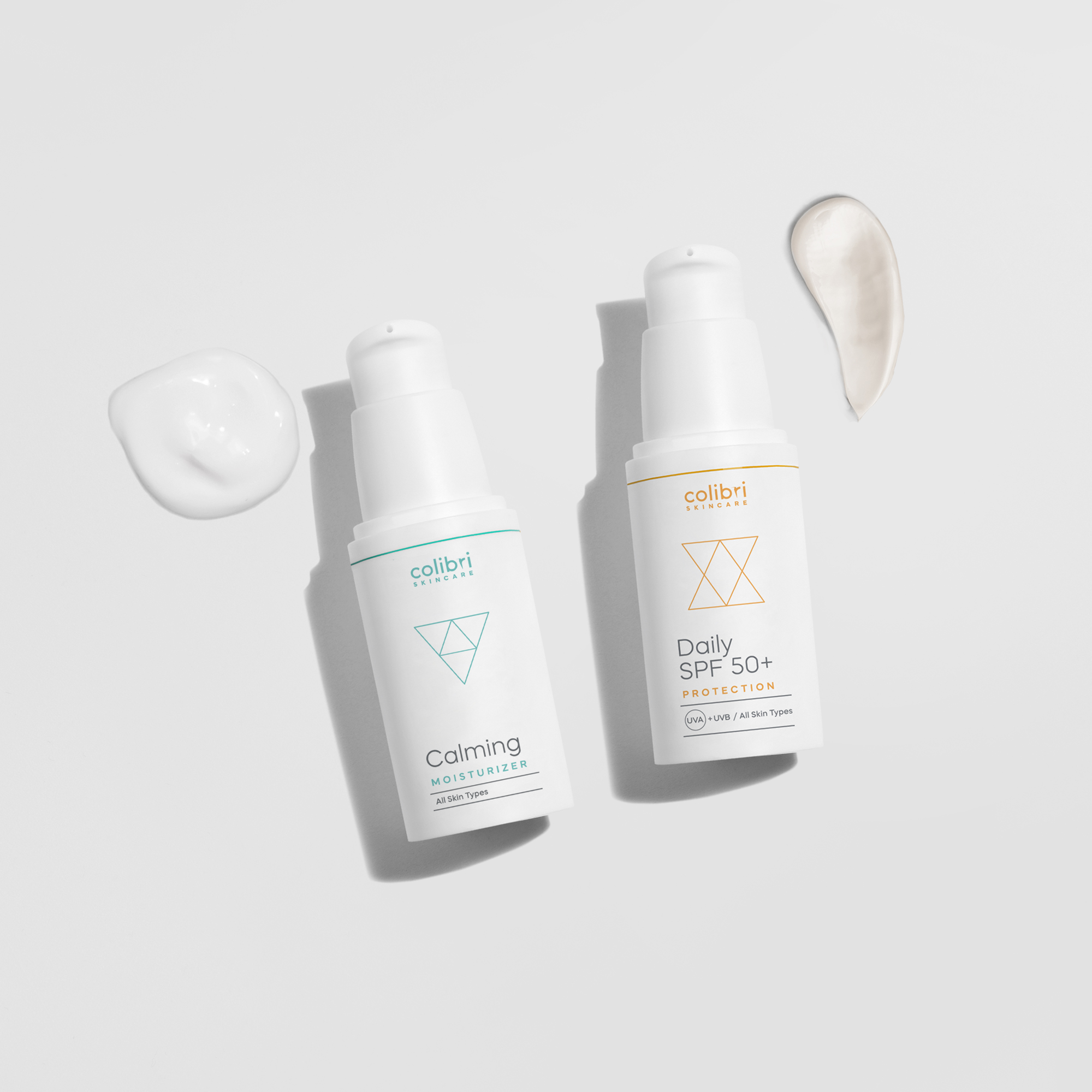 Two skincare bottles with cream swatches on a white background.