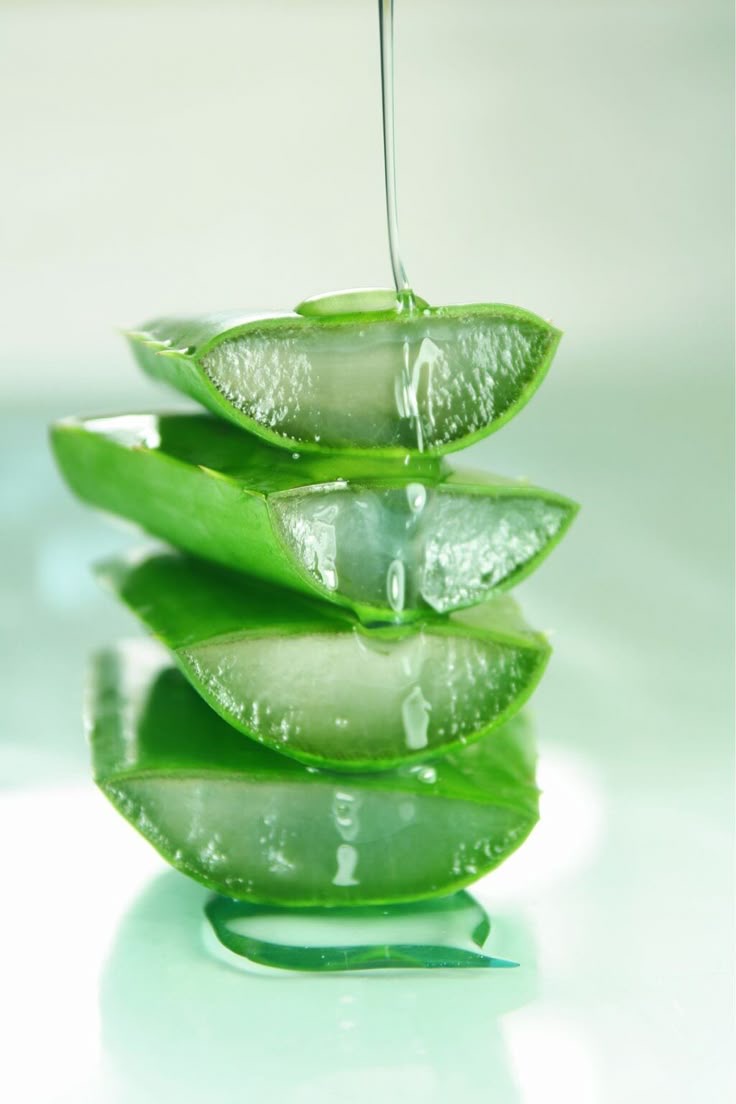 Stacked aloe vera slices with gel dripping down.