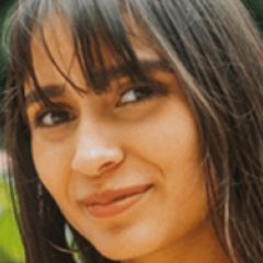 Close-up of a woman with dark hair smiling.
