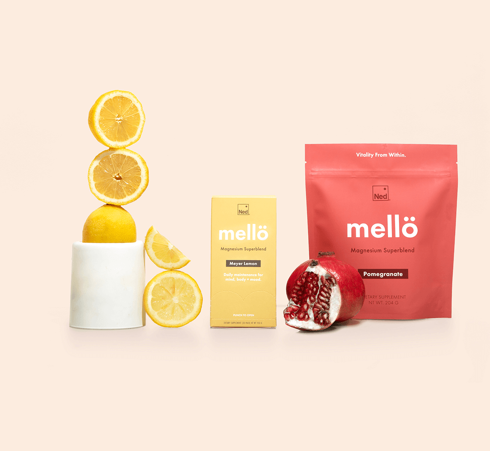 Two packages of magnesium superblend with lemons and a pomegranate.