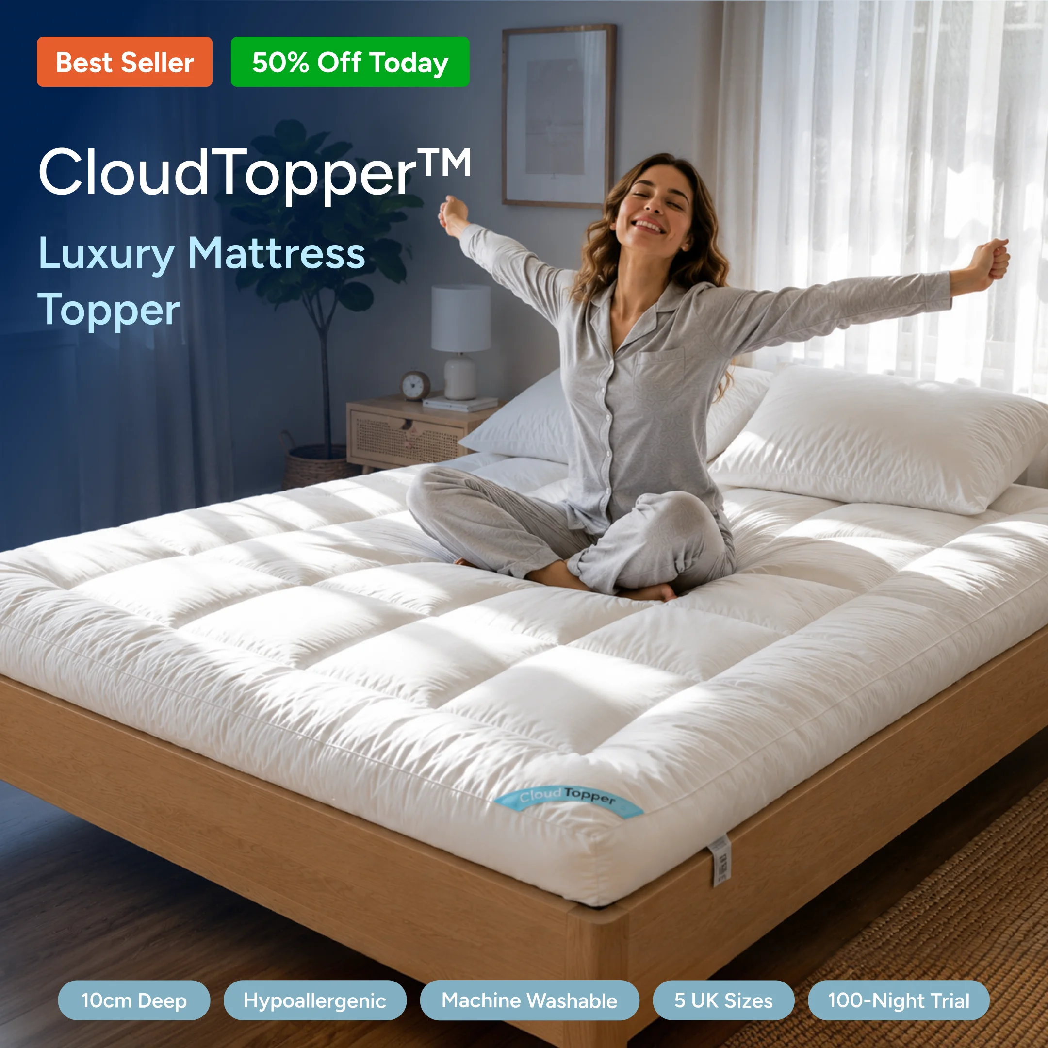 A happy woman in pajamas stretches while sitting on a thick, white CloudTopper mattress topper.