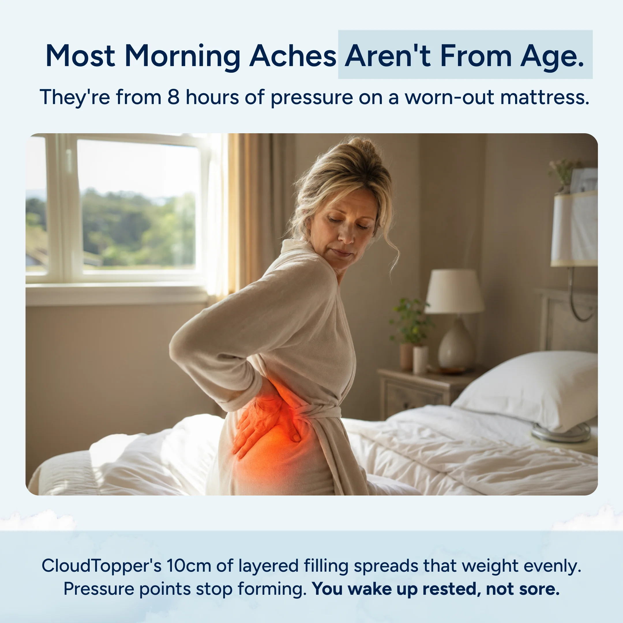 A woman in a bathrobe sits on her bed holding her lower back, which glows red to indicate pain.