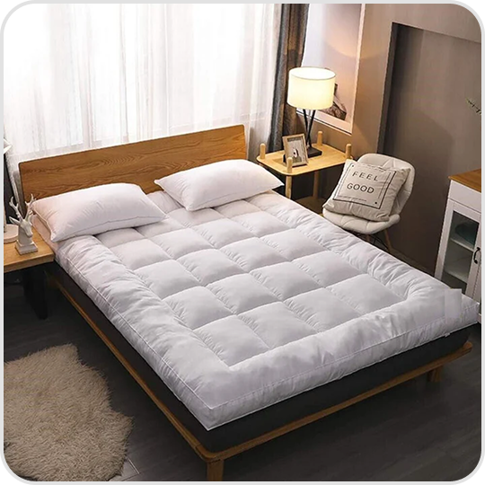 A neatly made bed with white bedding in a cozy bedroom.