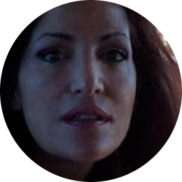 Close-up of a woman with long dark hair and subtle makeup.