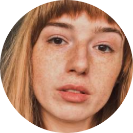 Close-up of a person with freckles and light brown hair.