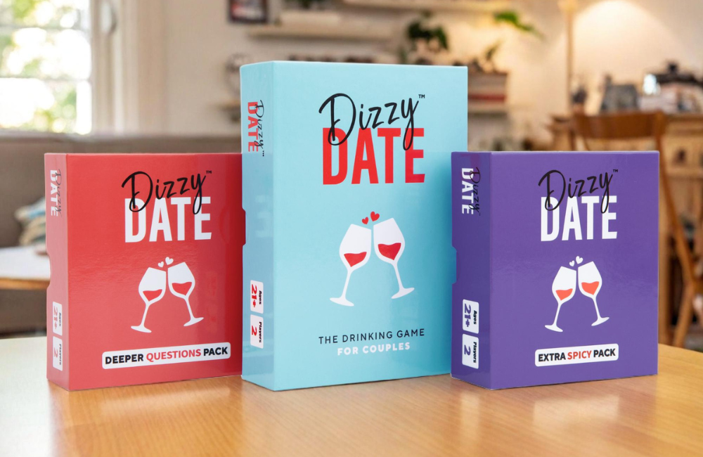 Three 'Dizzy Date' game boxes on a table.