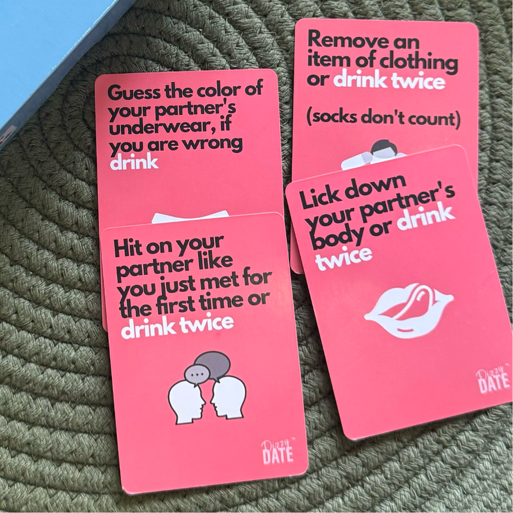 Four pink cards with playful drinking game instructions.