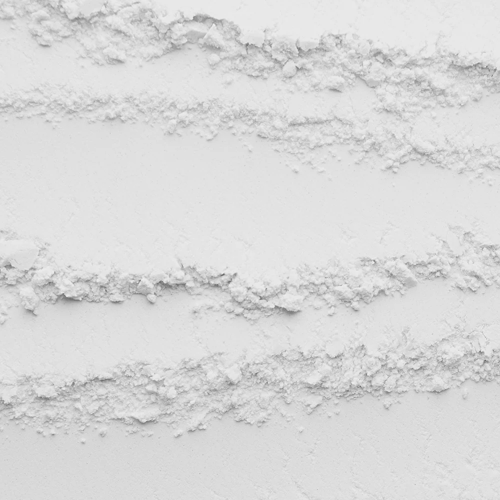 Close-up of white powder with textured lines.