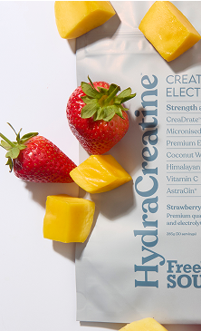 Strawberries and mango pieces on a HydraCreatine supplement package.
