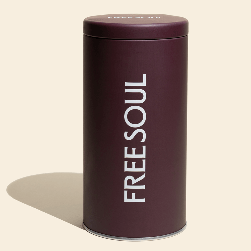 A tall, dark purple cylindrical tin with the brand name 'FREESOUL' in white text.