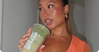 Person drinking from a cup with 'drink your greens' text.