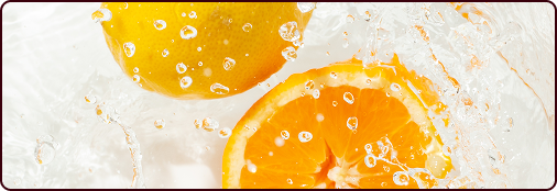 Orange slices splashing in water with bubbles.