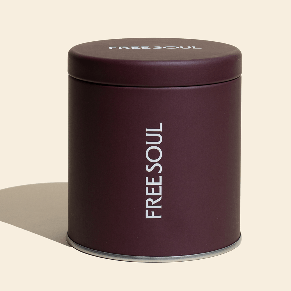 A cylindrical, dark purple canister with the words 'FREE SOUL' printed in white on the side and lid.