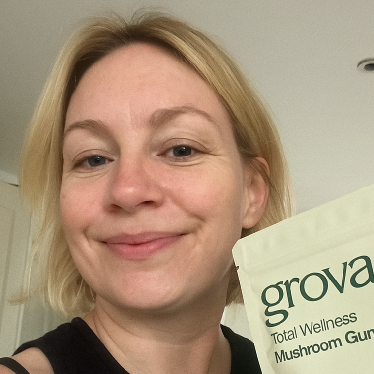 Happy customer holding Grova Mushroom Gummies, part of her daily wellness routine.