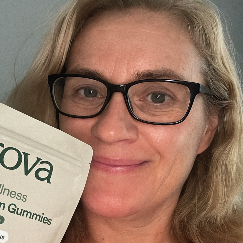 Woman with glasses holding Grova Mushroom Gummies, smiling and endorsing the product.