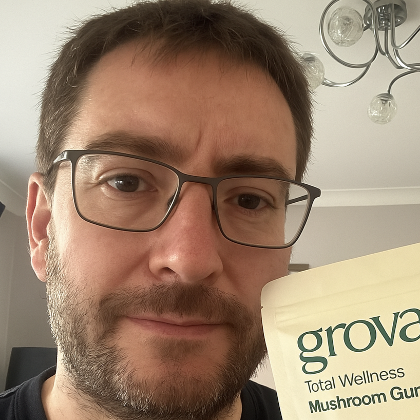 Man holding a pouch of Grova Mushroom Gummies, showing his support for the wellness supplement.