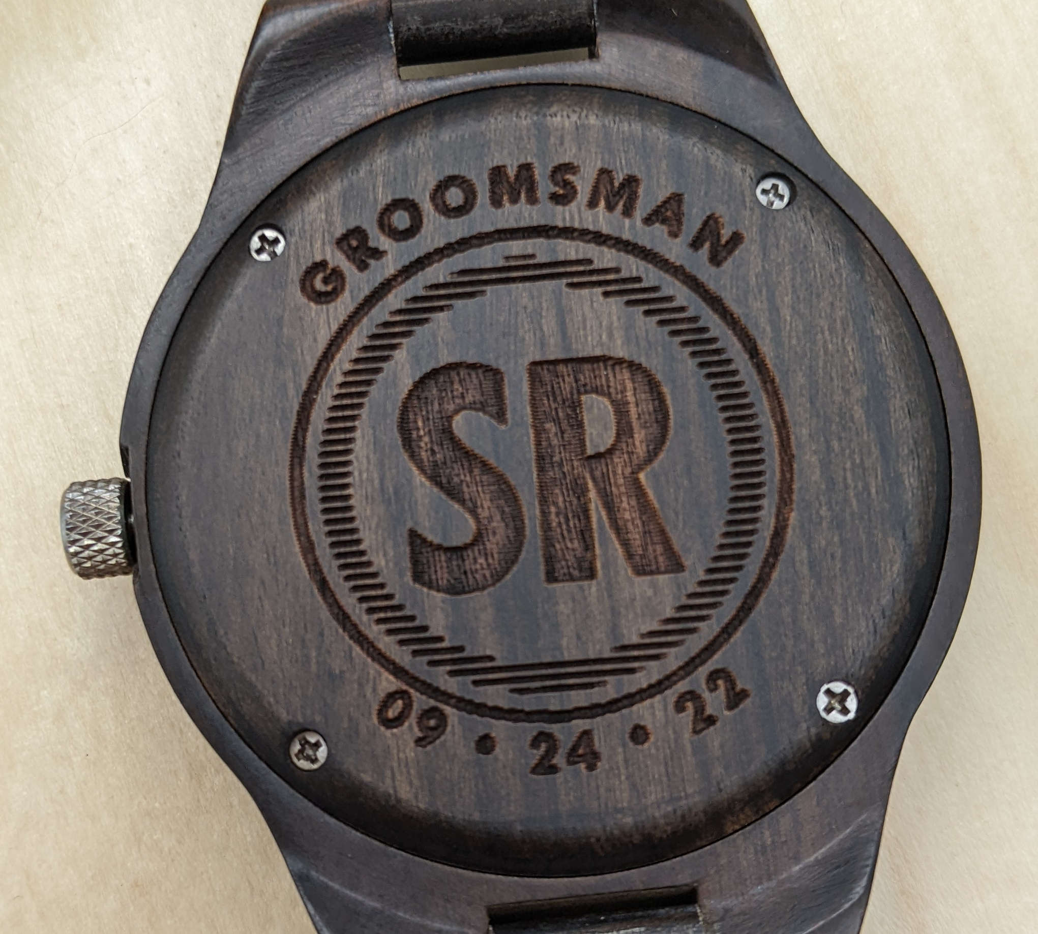 Wooden watch back engraved with 'Groomsman,' 'SR,' and the date '09-24-22.'