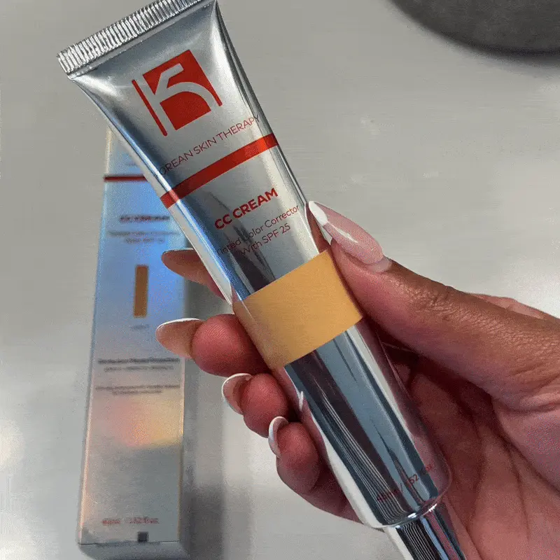 Person holding a tube of CC cream with SPF 25.