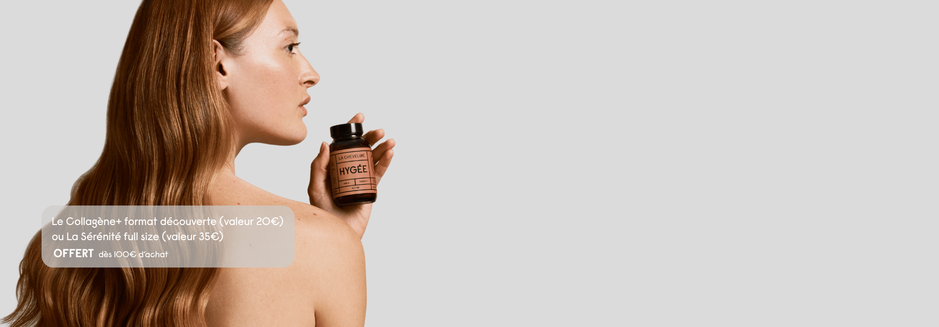 Person holding a HYGÉE product bottle with wavy hair on display.