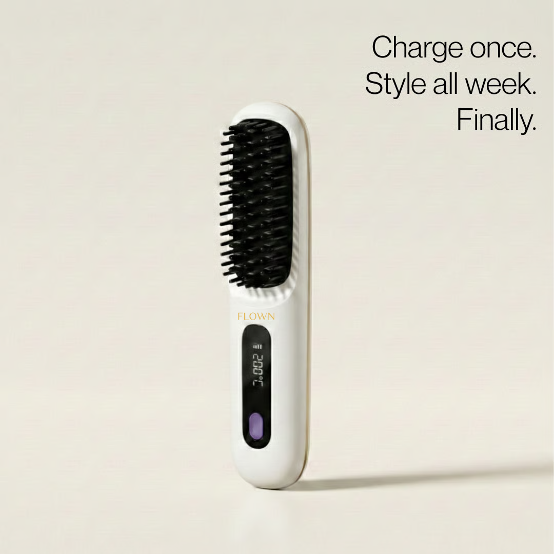 A white, cordless straightening hairbrush with a digital display stands upright against a plain background.