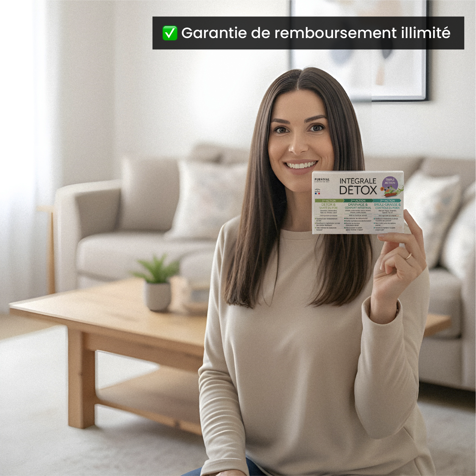 Woman holding a detox product in a living room, smiling at the camera.
