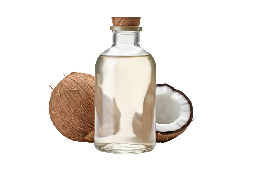 Glass bottle of coconut oil with whole and halved coconuts.
