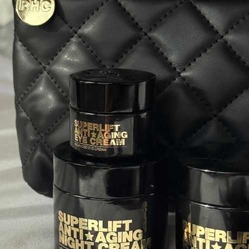 Black quilted bag with Superlift anti-aging cream containers.