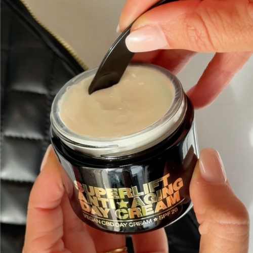 Hands holding a jar of Superlift Anti-Aging Day Cream.