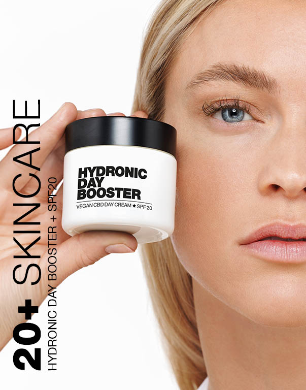 Person holding a jar of Hydronic Day Booster skincare cream.