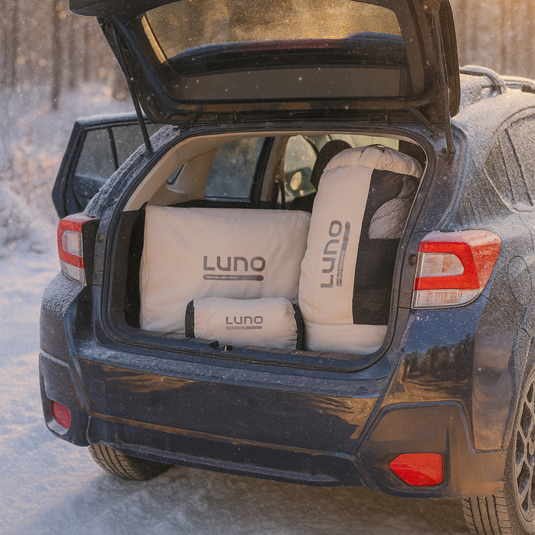 Open car trunk with Luno branded camping gear inside.