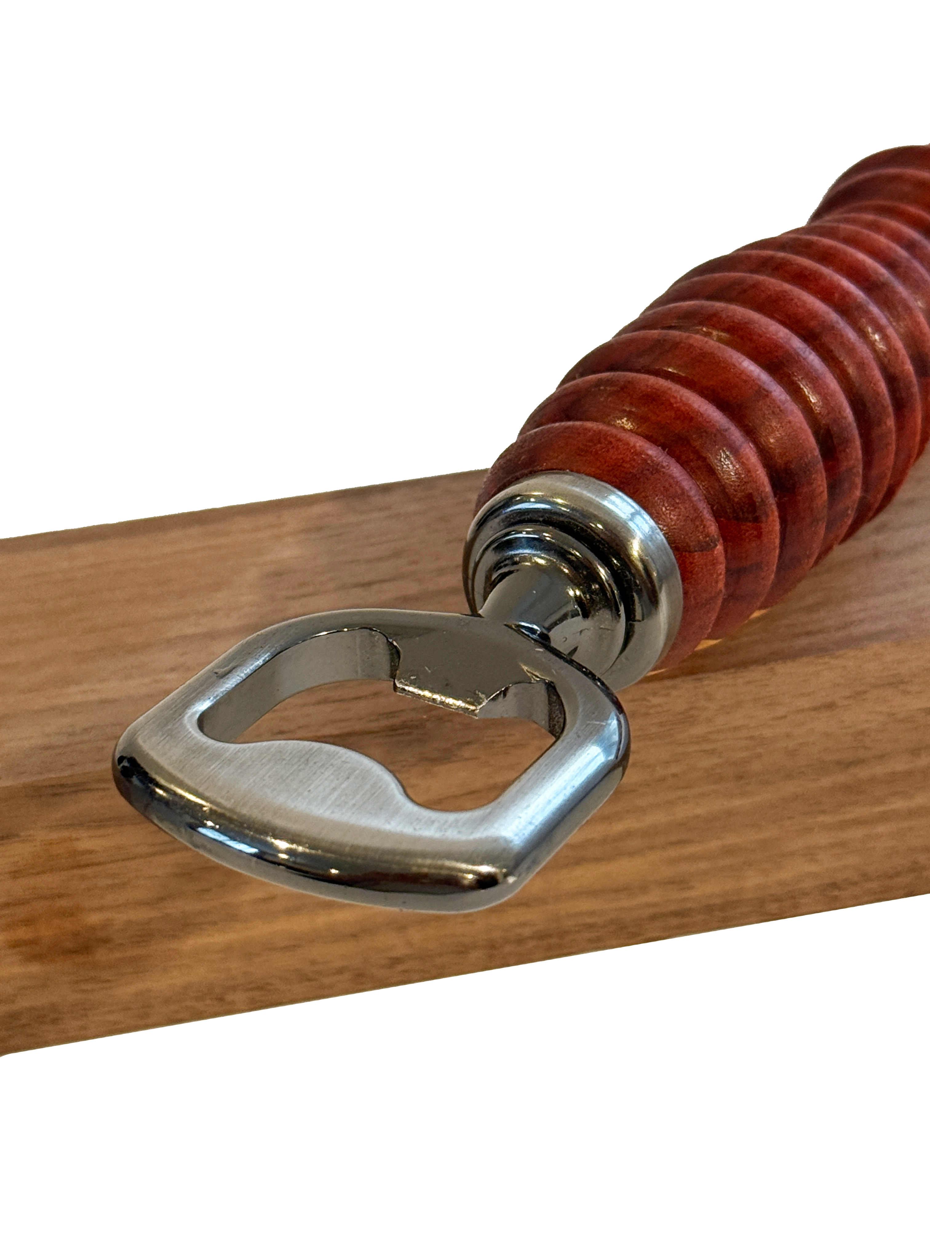 Wooden-handled metal bottle opener on a wooden surface.