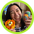 Person smiling, holding a crocheted lion and colorful eggs.