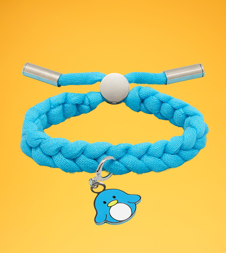 Blue braided bracelet with a penguin charm on a yellow background.
