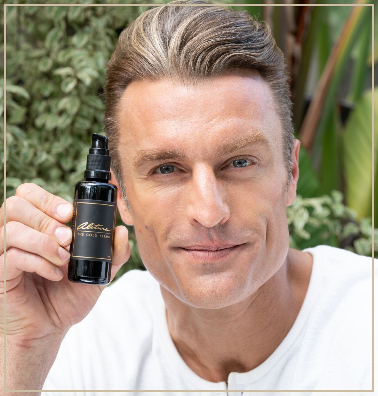 Person holding a skincare product bottle in an outdoor setting.