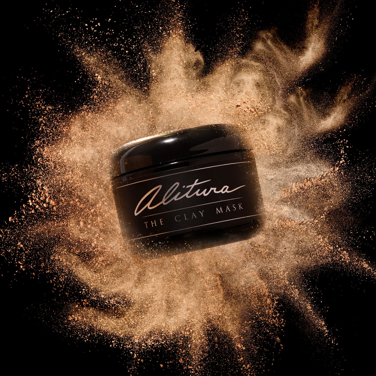 Black jar of clay mask surrounded by a burst of clay particles.