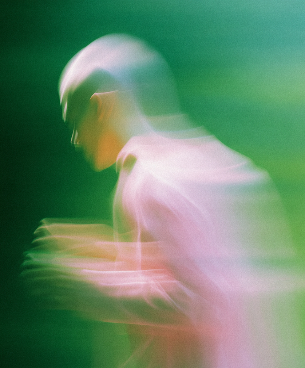 Abstract motion blur of a person with green background.