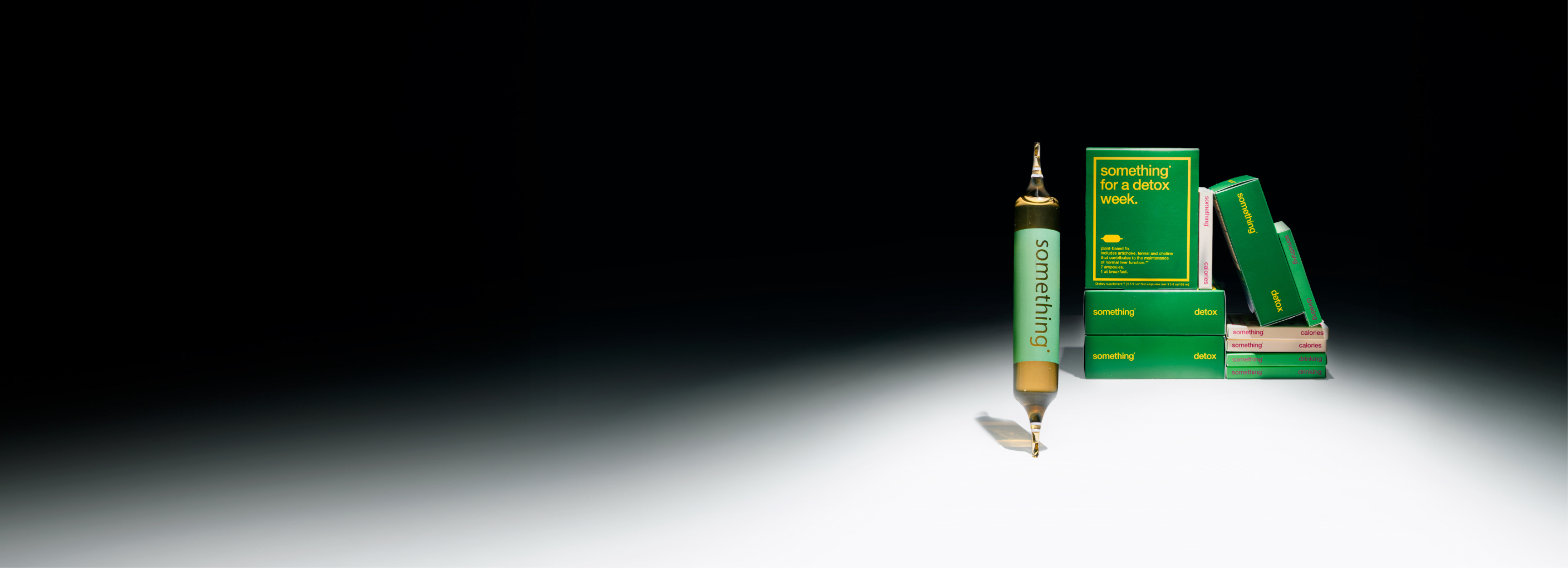 Green boxes and a cartridge with 'something' written, arranged against a dark background.