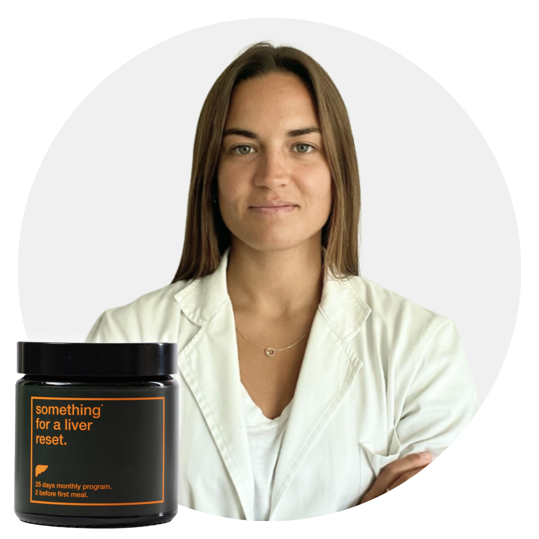 Woman in a white coat with a jar labeled 'something for a liver reset.'