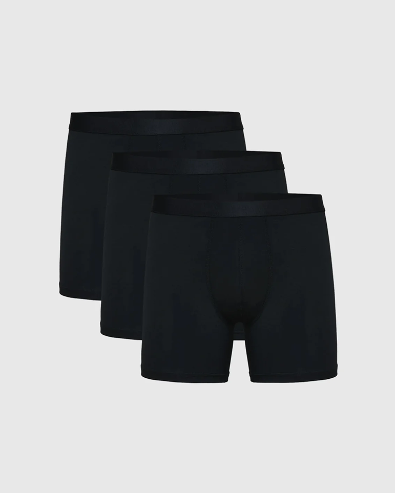 Three black boxer briefs on a plain background.