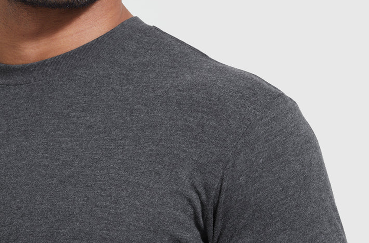 Close-up of a person wearing a dark gray t-shirt.