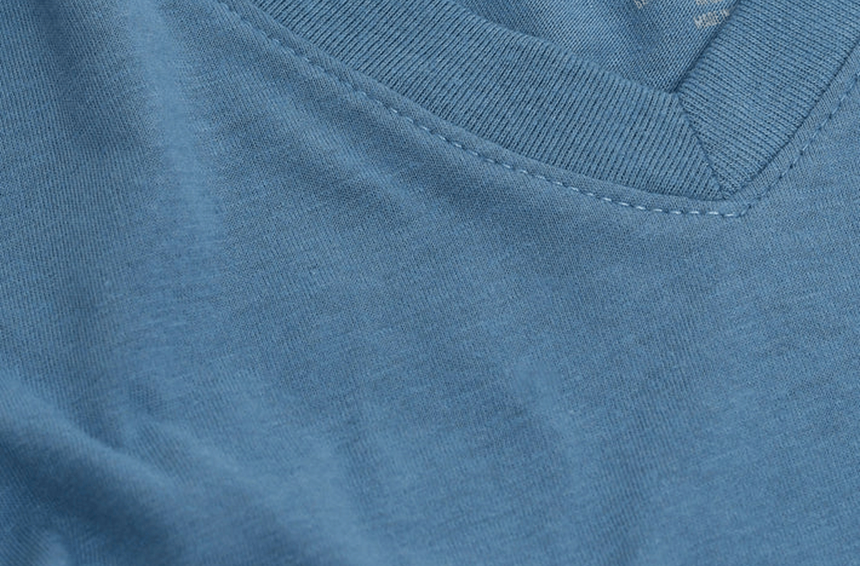 Close-up of a blue V-neck fabric with visible stitching.
