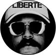 Man wearing sunglasses and a 'LIBERTE' cap.